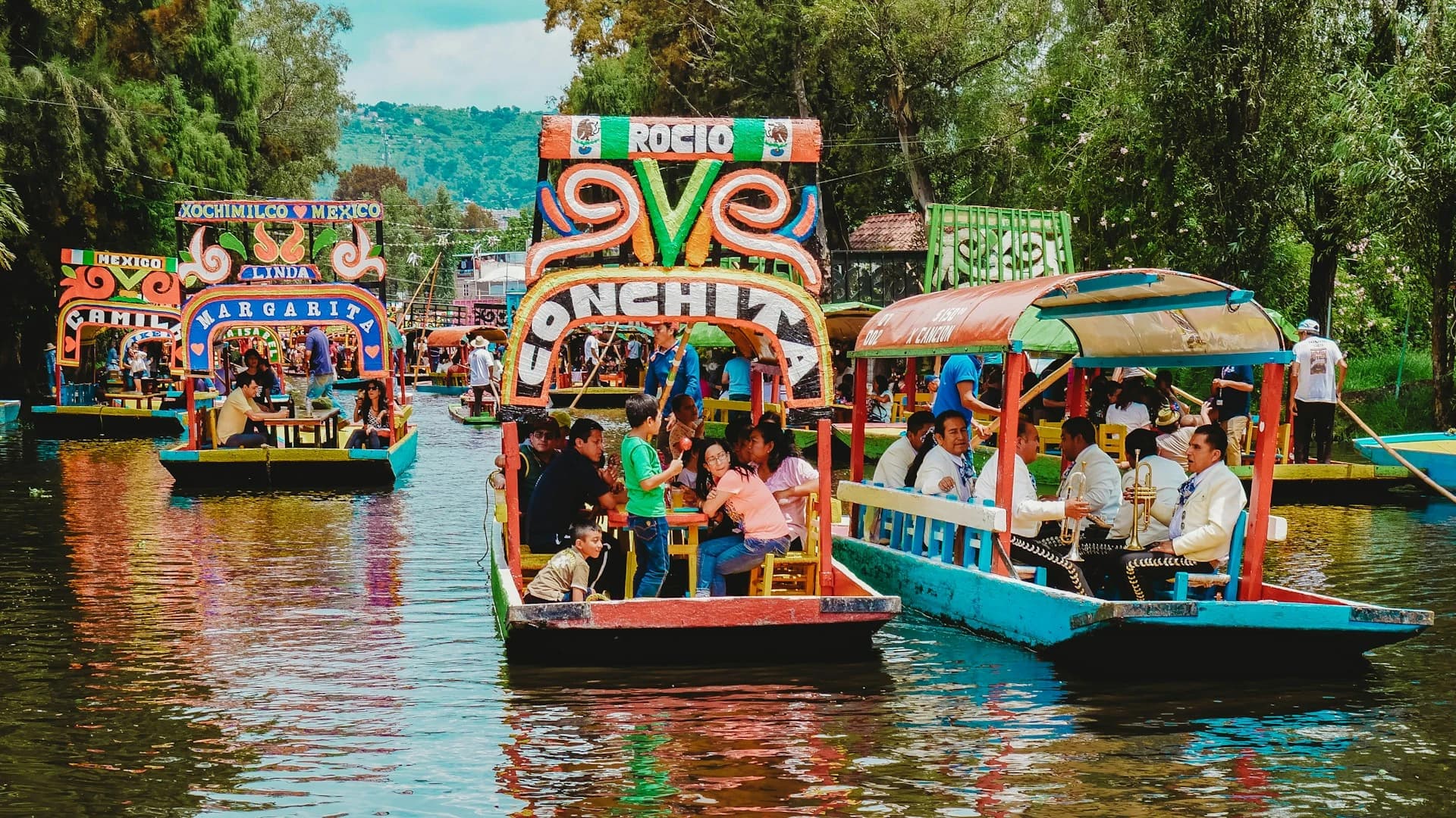 Brightly painted trajinera boats crowded together on the canals of Xochimilco