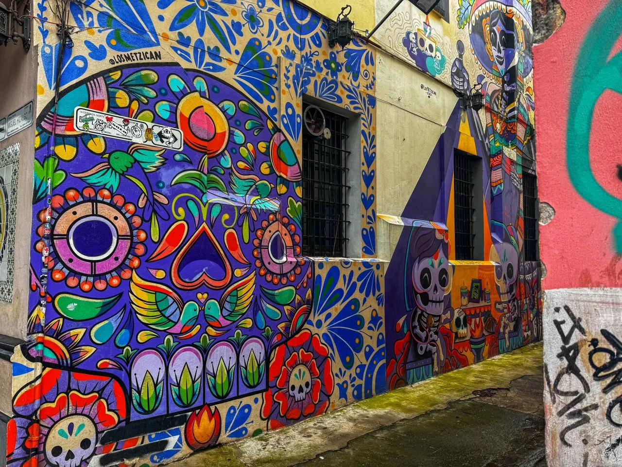 Colorful street art mural depicting Día de los Muertos in Mexico City