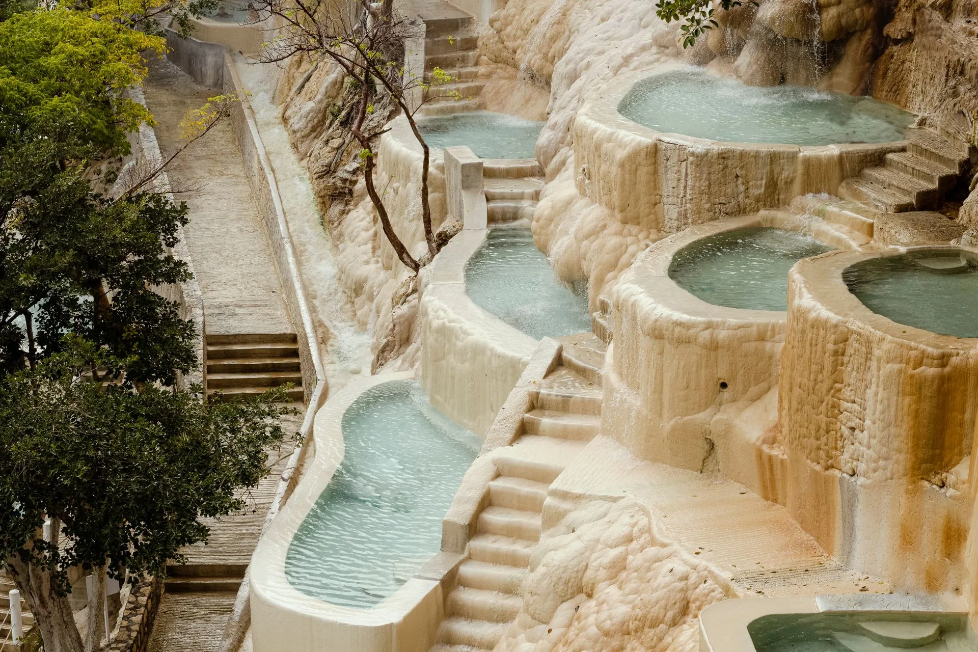 Terraced turquoise hot spring pools built into the canyon wall at Grutas de Tolantongo in Hidalgo, Mexico