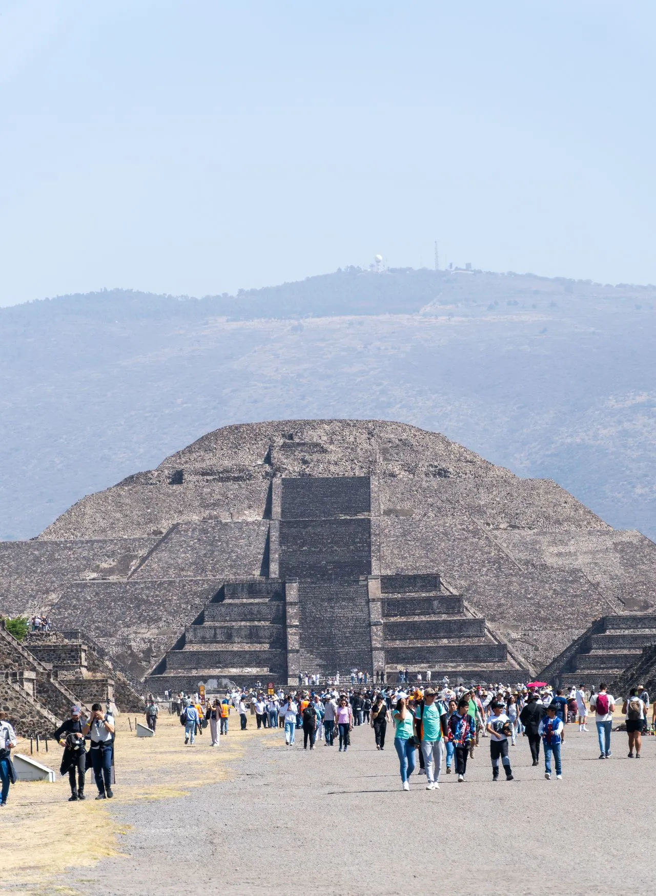 Tourists exploring the ancient site of the Pyramid of the Sun in Teotihuacan, Mexico