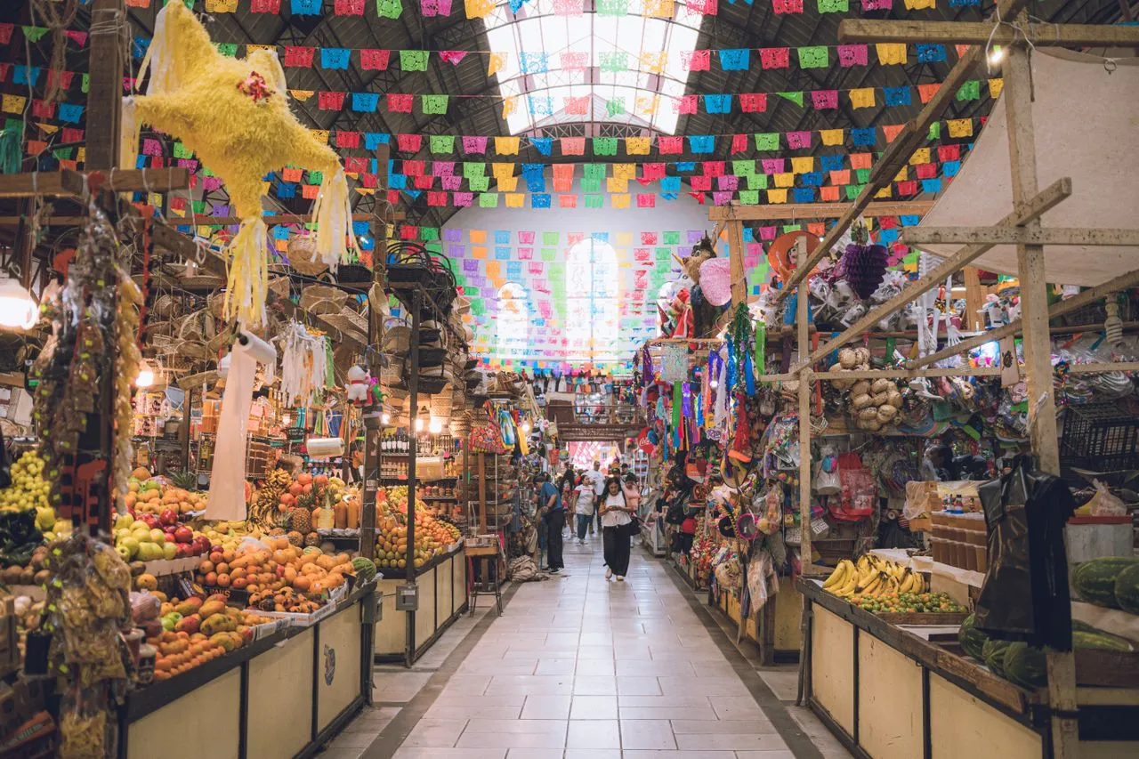 Stalls of fresh produce, chiles and local ingredients at a colorful market in Mexico